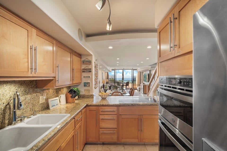 Spacious kitchen with granite countertops and double sink for easy meal prep