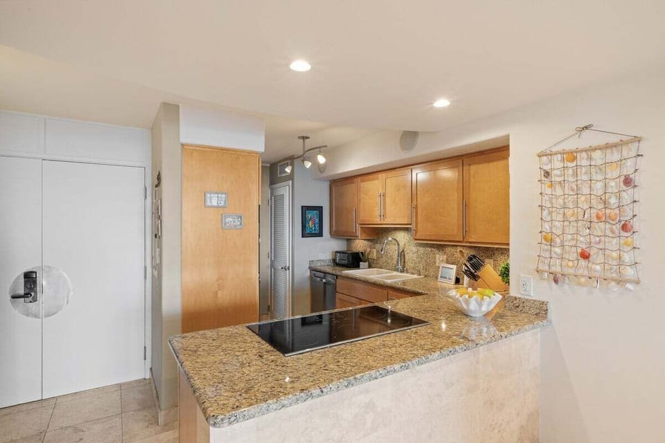 Modern kitchen featuring granite countertops and sleek cooktop