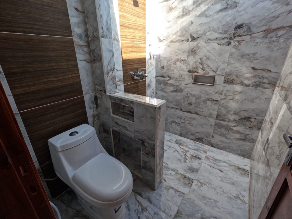 Deluxe Bungalow, Sea View | Bathroom | Shower, rainfall showerhead, towels, soap