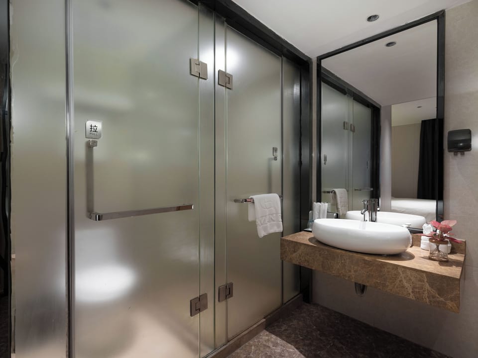 Shower, hair dryer, slippers, towels