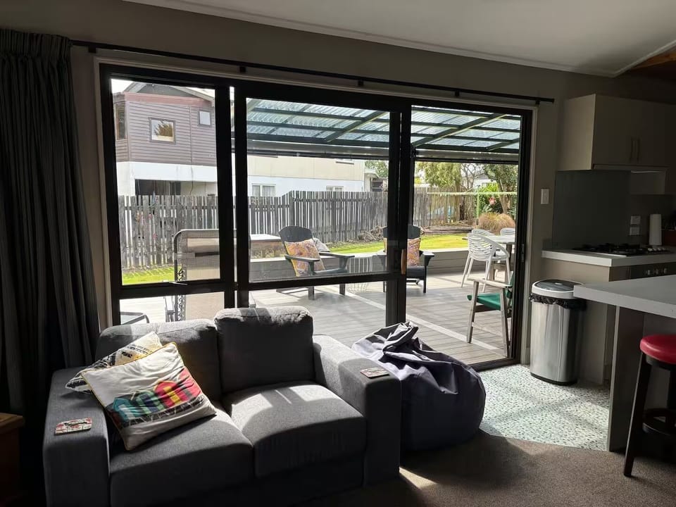 Lounge area leading out to covered in deck area
