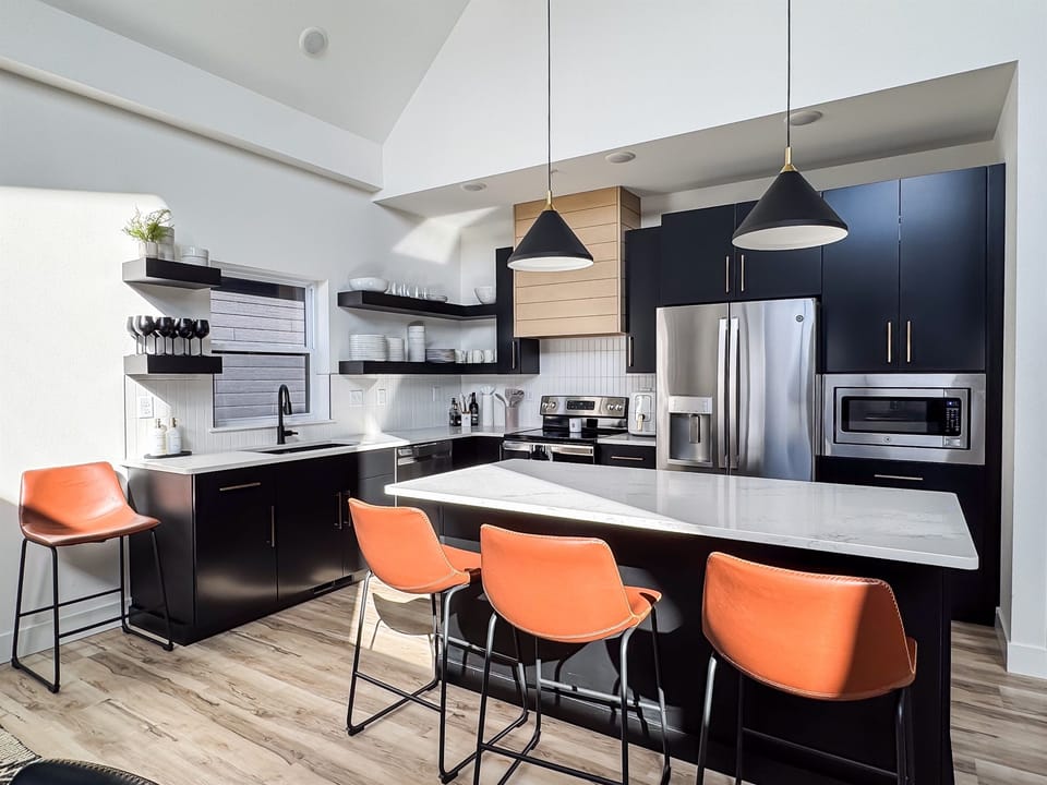 Island area provides more area to prep or seating to eat at