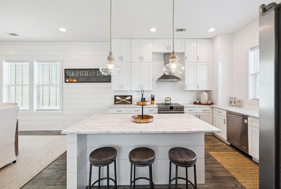Gather around this pristine white kitchen island where you'll create memories over morning coffee and evening conversations.