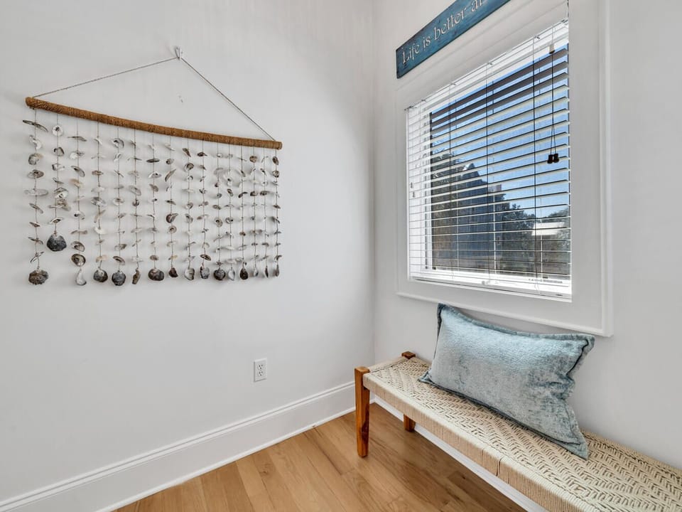 Curl up in your cozy window nook with a good book, surrounded by coastal charm and natural light streaming through.