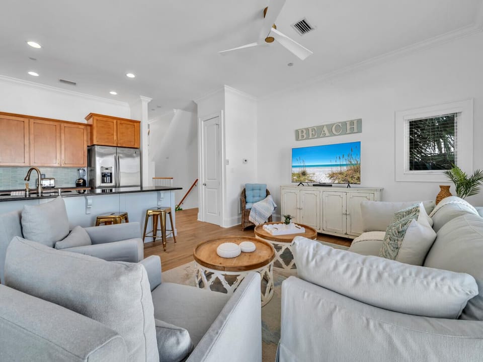 Relax in your bright, open living space with beach-inspired decor and a fully equipped kitchen perfect for preparing coastal meals.