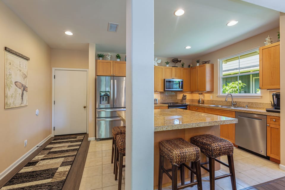 The fully equipped kitchen offers modern appliances and a spacious layout for easy meal prep.
