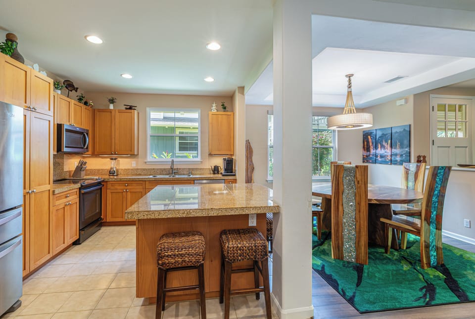 The kitchen island provides additional counter space and seating for four.