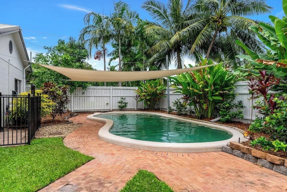 Dive into your private oasis, where a sparkling pool, sun loungers, and lush greenery create the perfect setting for cooling off and soaking up the tropical vibes.