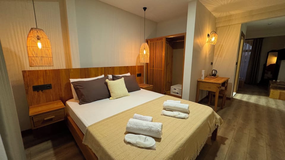 Deluxe Room, Pool View | Free minibar, in-room safe, desk, laptop workspace