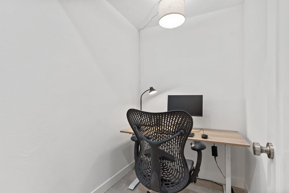 Enclosed, dedicated office room features a Herman Miller chair for your comfort
