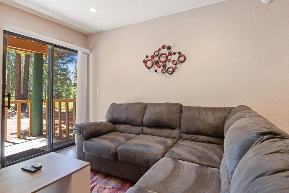 Studio living room with Smart TV, gas fireplace, dining area and murphy bed