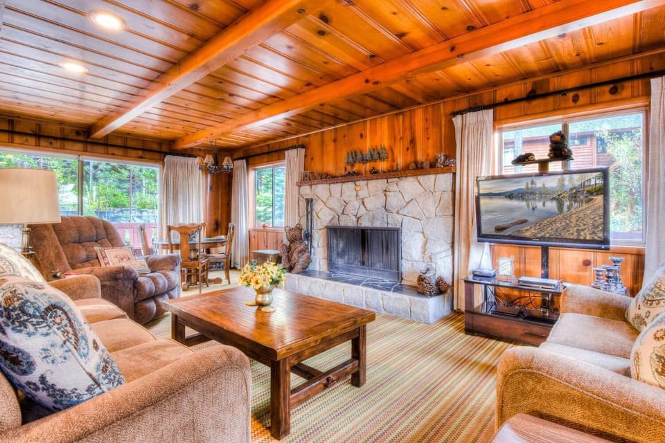 Living room w/ flat screen TV, DVD player, wood burning fireplce