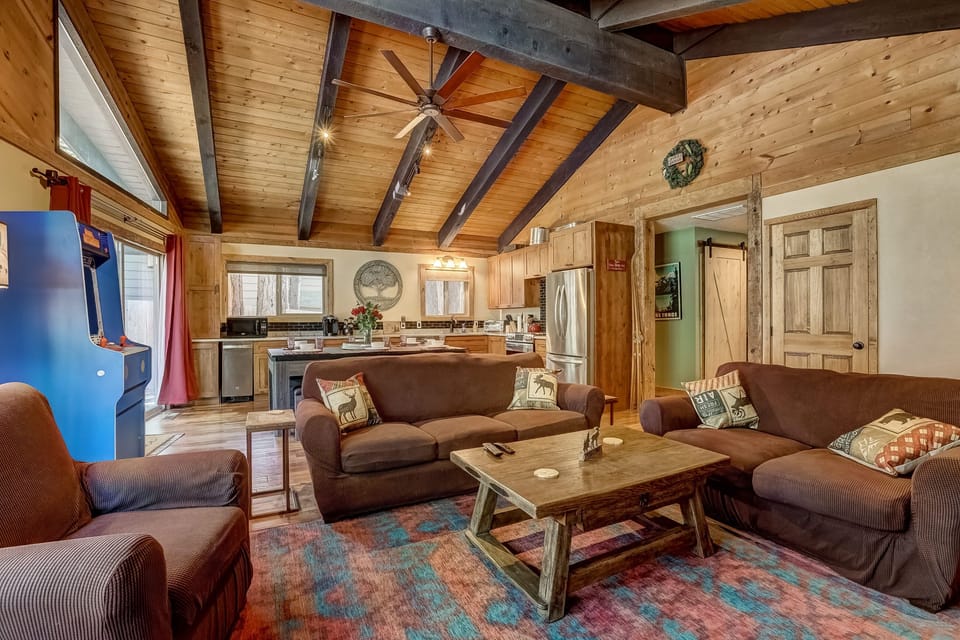 Living room with Smart TV, wood burning fireplace, backyard access and comfortable seating
