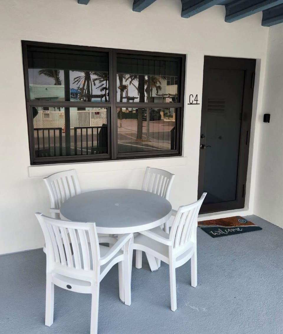 Covered front porch area with outdoor furniture