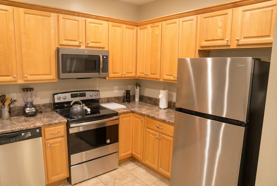Bright full kitchen with stainless appliances and plenty of cabinet space