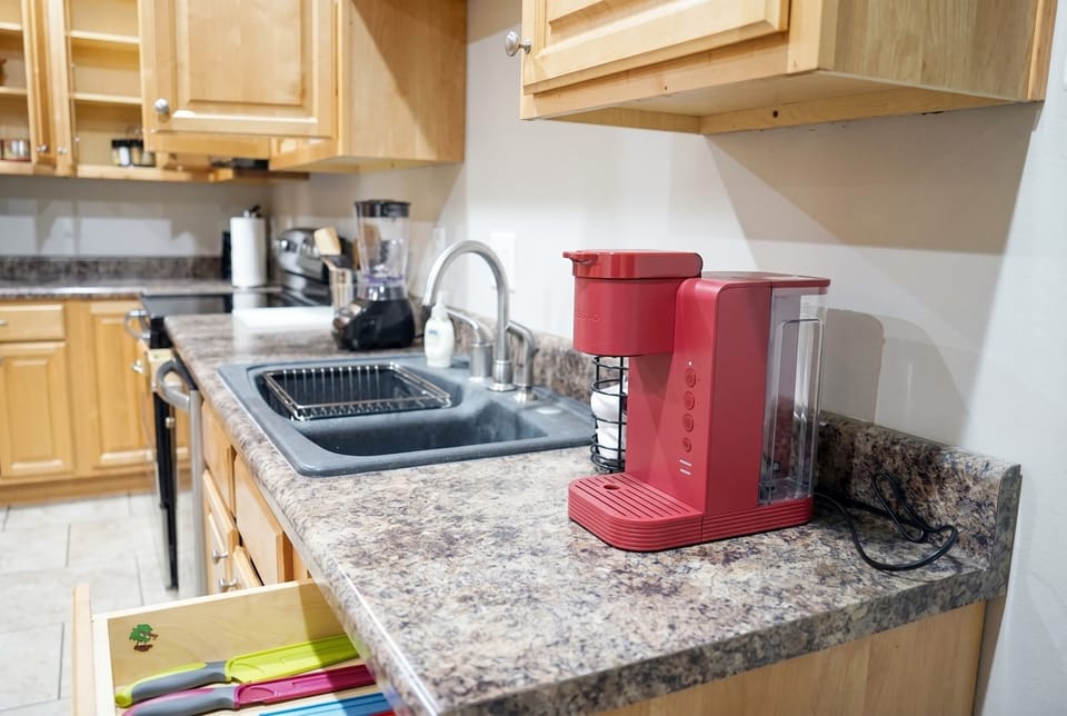 Well-stocked kitchen with coffee maker, blender, and generous counter space