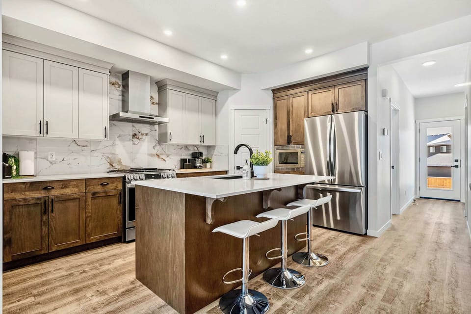 A kitchen that earns its keep - island seating, gas range, and room for the whole group to gather.