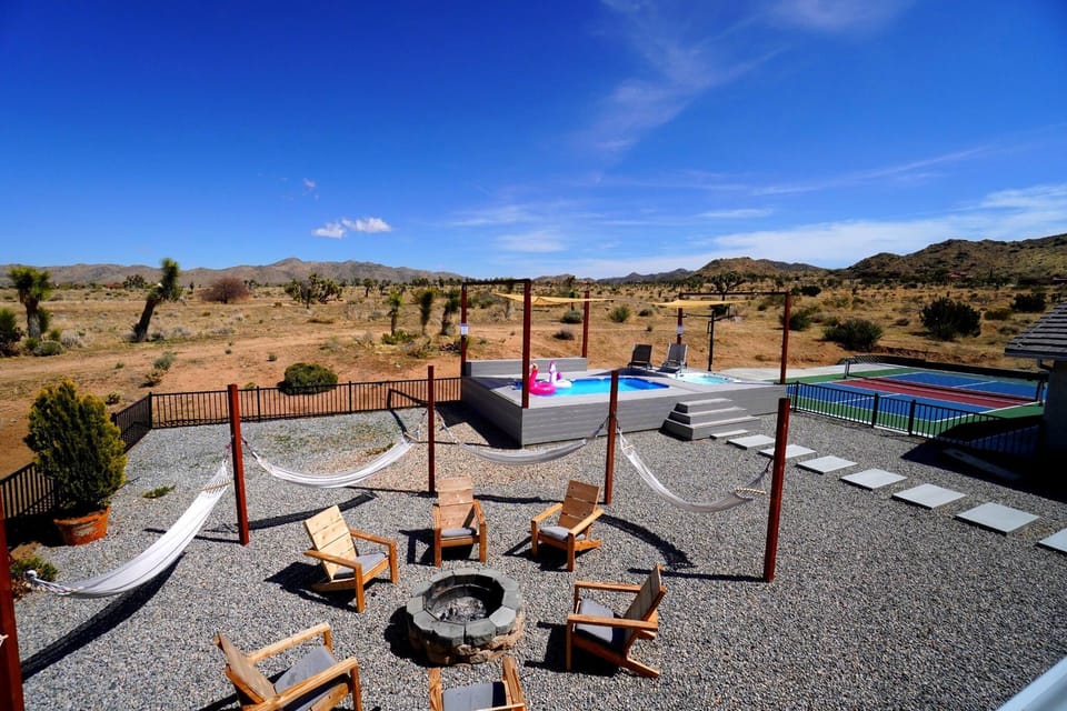 Outdoor space with pool, hot tub, pickleball, and fire pit