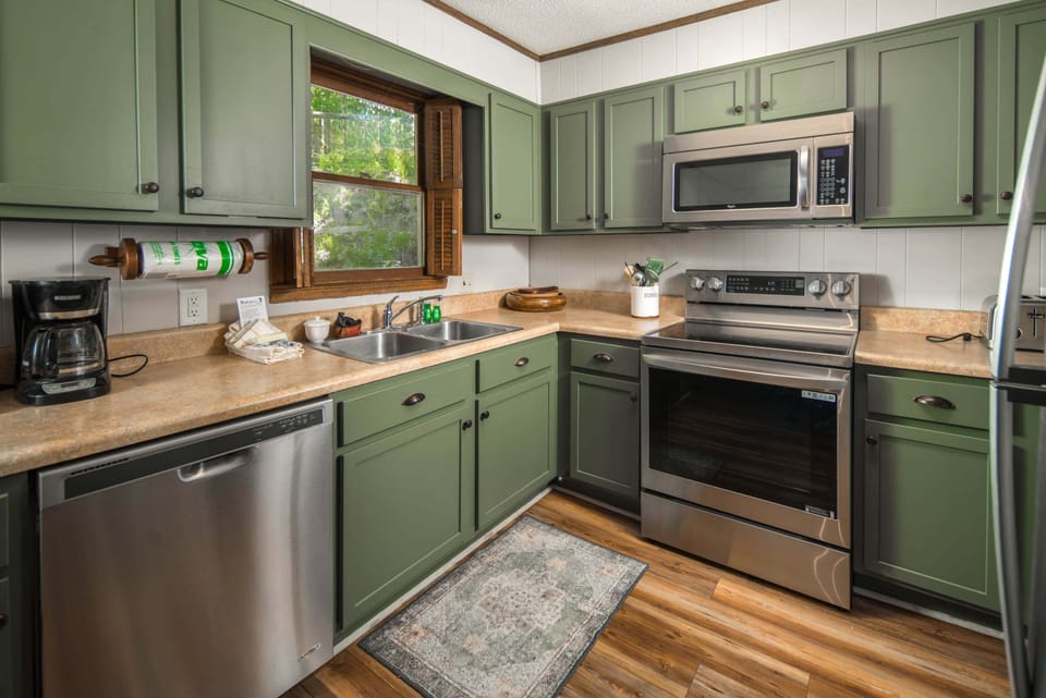 Bright mountain cabin kitchen featuring modern appliances and everything needed for a comfortable stay