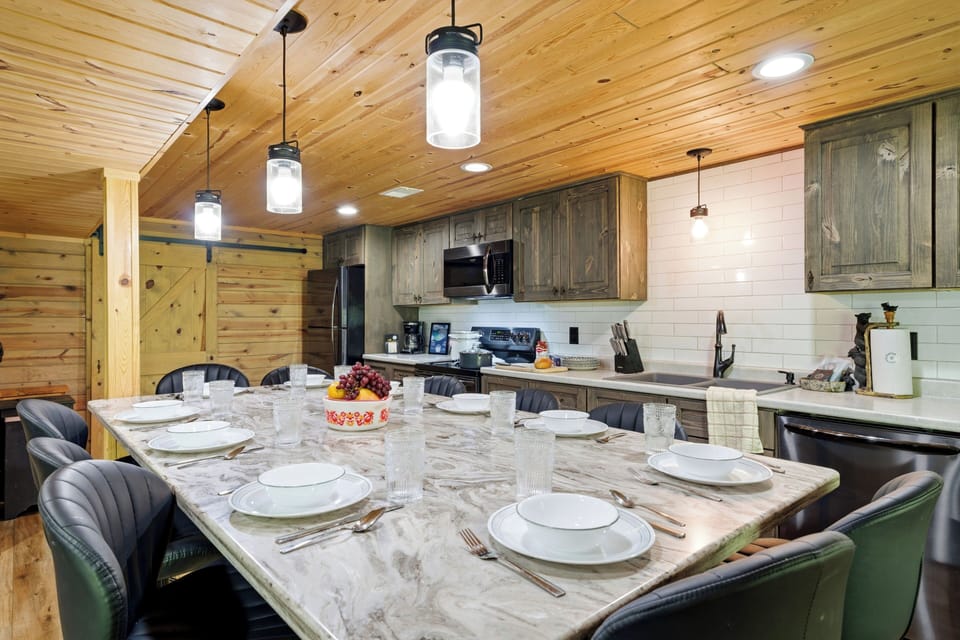 Share meals around the spacious dining table with a fully equipped kitchen, warm wood details, and plenty of room for everyone to gather.
