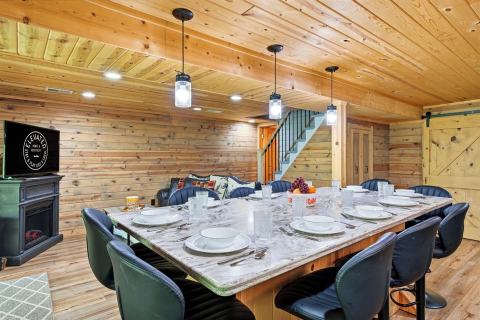 Gather around the spacious dining setup with cozy cabin charm, warm wood finishes, and easy access to the lounge for after-dinner relaxing.