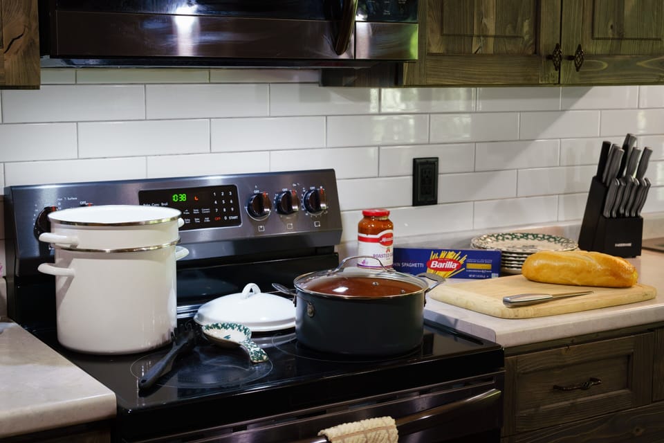 The kitchen comes ready with cookware, utensils, and modern appliances so you can enjoy homemade meals without leaving the cabin.