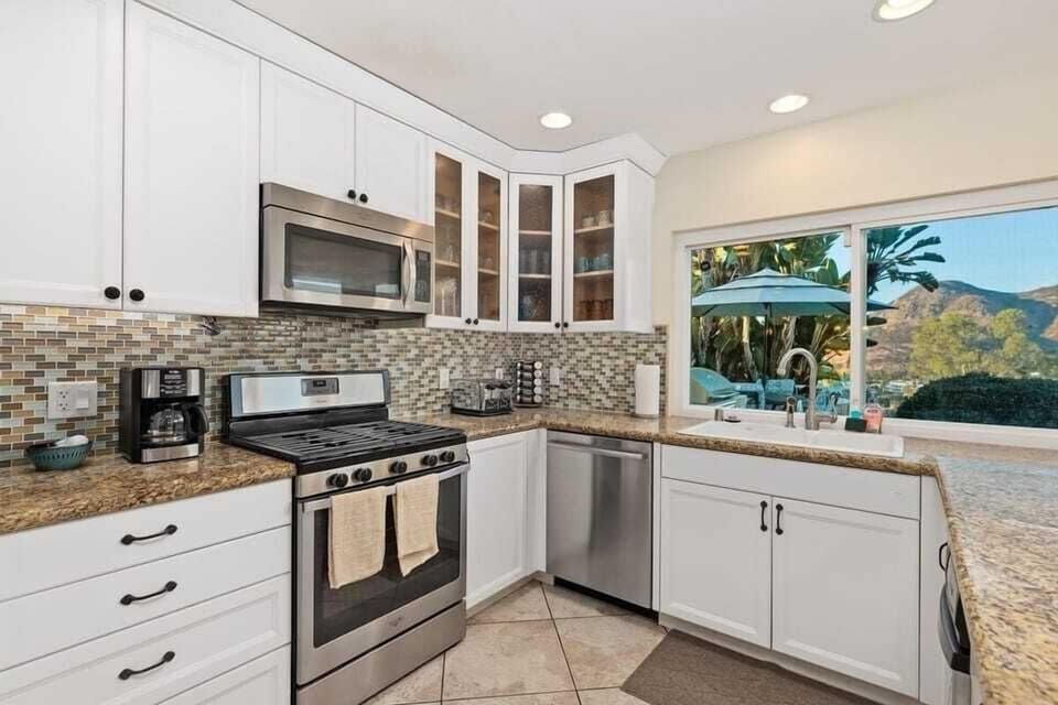 Fully-stocked kitchen with bar stools