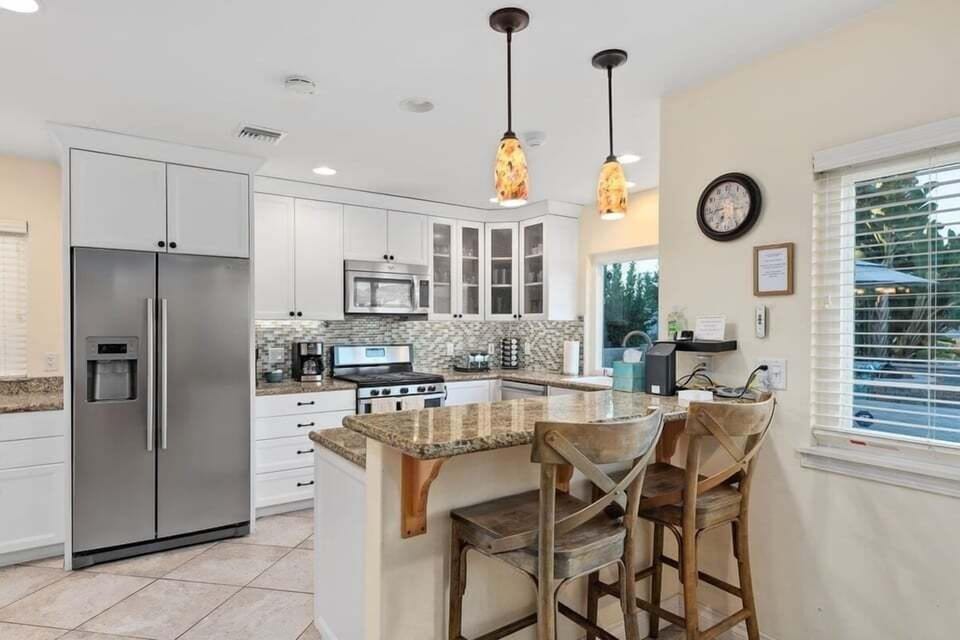 Fully-stocked kitchen with bar stools