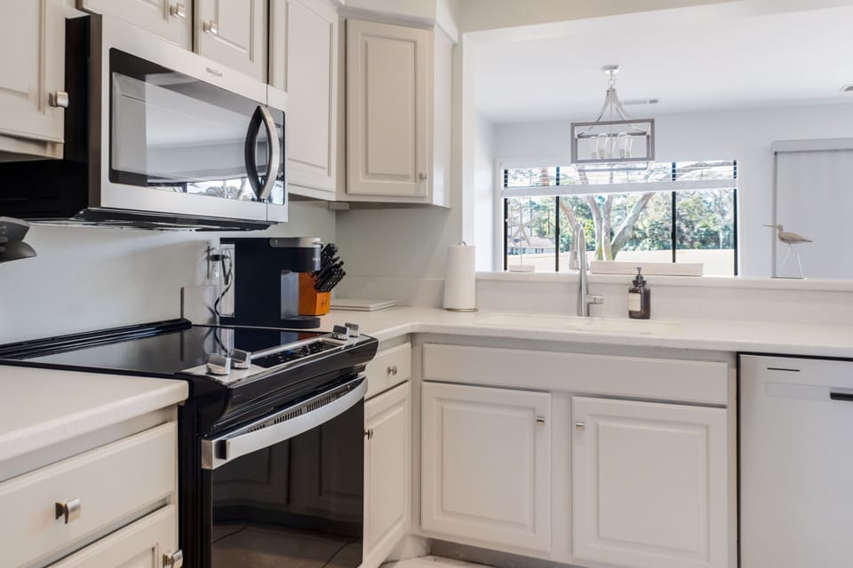 Kitchen with new stainless steel appliances and full cookware set