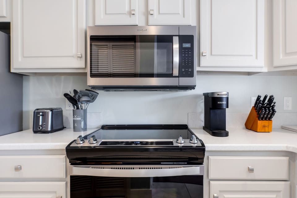Kitchen with new stainless steel appliances and full cookware set