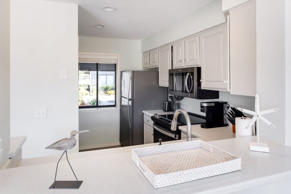 Kitchen with new stainless steel appliances and full cookware set