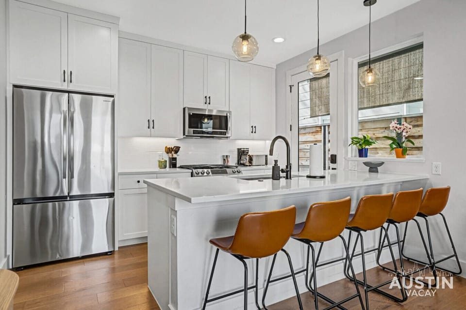 Bright, modern kitchen with a big island and bar seating for five.