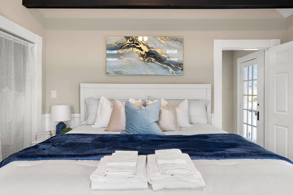 Sink into luxury in this spacious master bedroom with a king-sized bed, perfect for restful nights and lazy mornings.