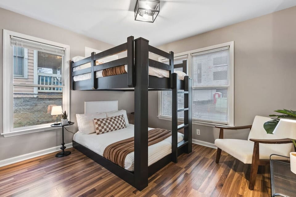 Bedroom 2 has Queen over Queen bunk bed. Room darkening shades, Closet with hangers and shelf, chair for seating.
