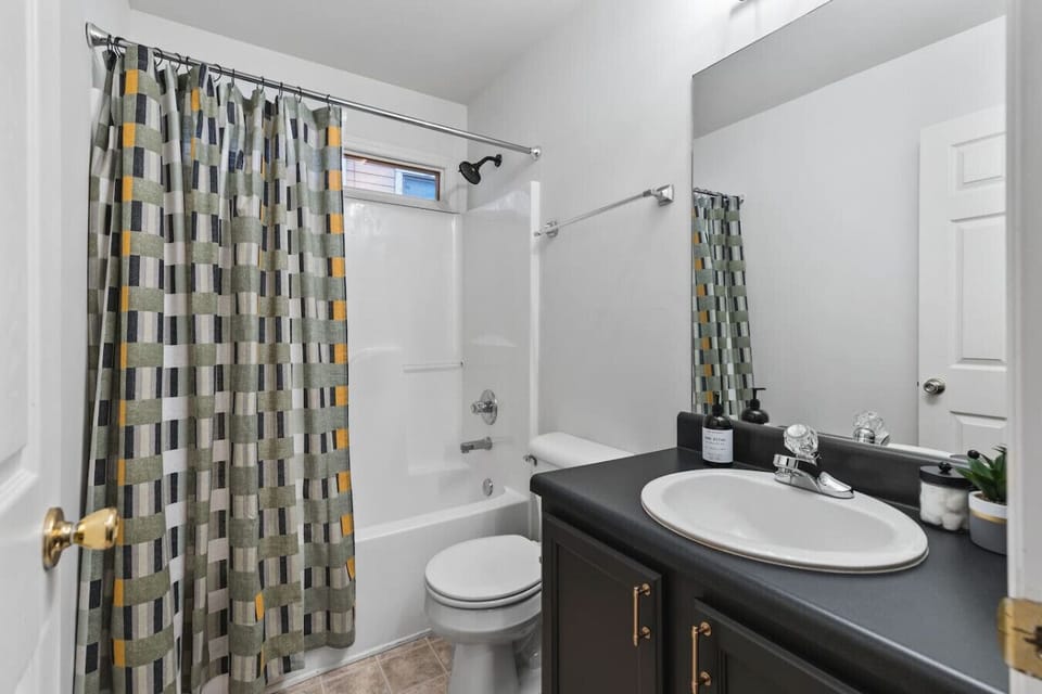 Bathroom #1 - Large full size bathroom with shower/tub combo + bathroom essentials located down the hall from bedrooms 1 and 2.
