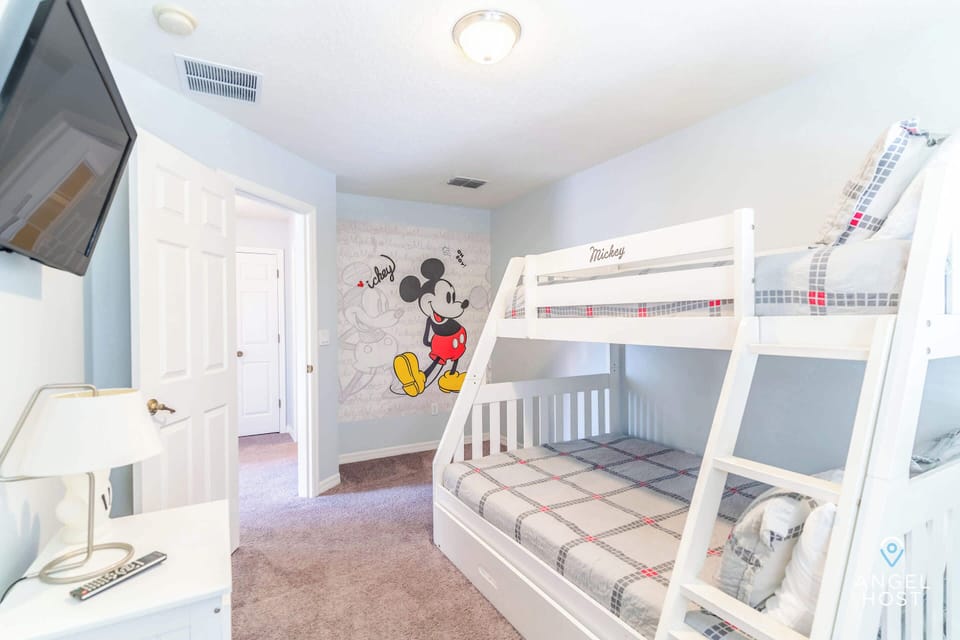 Bedroom 4 with a Mickey theme, featuring a bunk bed and a single bed.