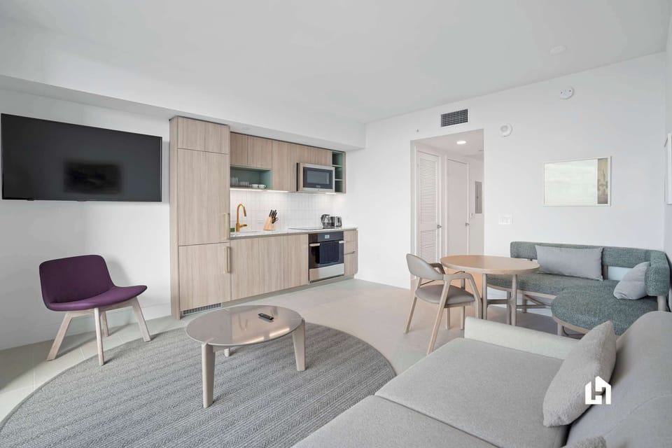 Modern kitchen & comfy seating await! Enjoy your stay.