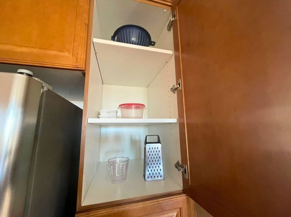The kitchen at Condo 11-3 includes cookware, utensils, plates, glasses, and silverware — plus a coffee maker and blender, ready for home-cooked meals just steps from the El Dorado Ranch community pool .