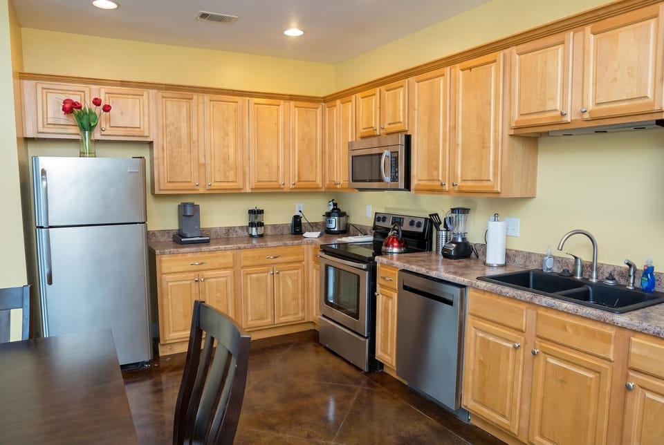Spacious full kitchen with stainless appliances and ample counter space