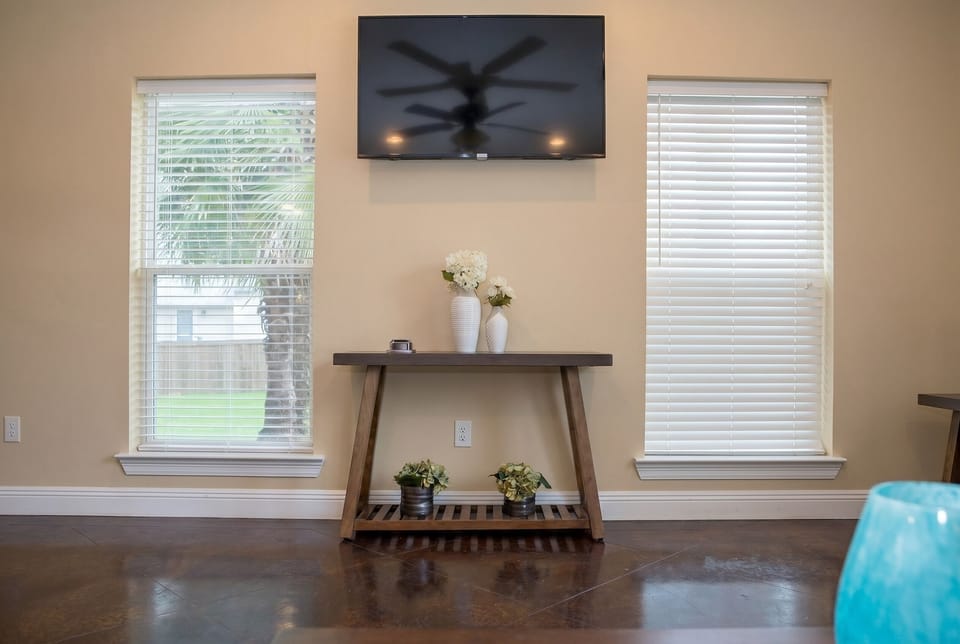 Bright living space with wall-mounted TV and stylish modern decor