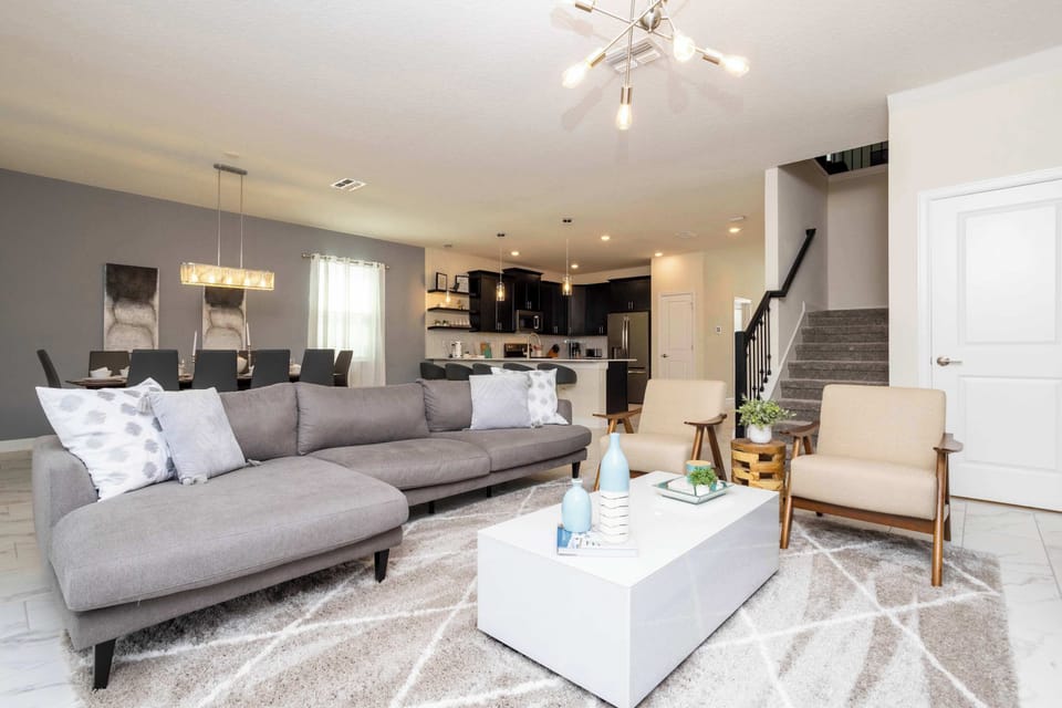 Large and spacious open floor plan connects the living room, dining room and kitchen. 10 top table and barstools at the counter provide plenty of space for everyone to dine together!