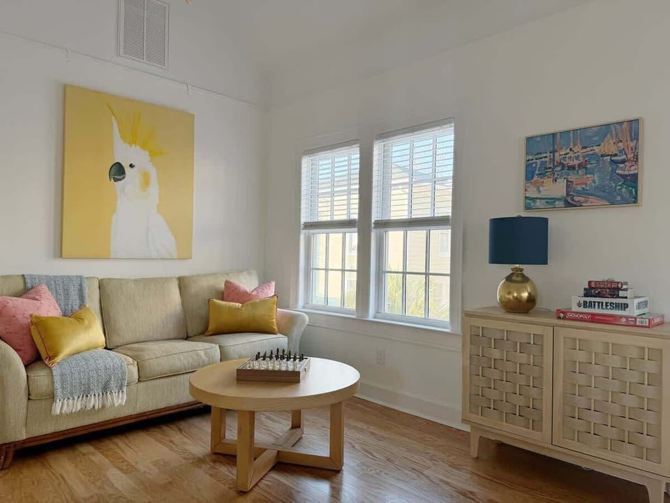 Spacious and modern living room with a Smart TV, pullout sofa, and a coffee table.