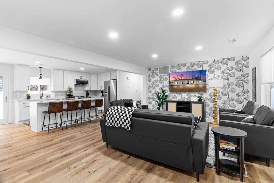 Discover a beautifully remodeled, open-concept living room that seamlessly flows into the kitchen, featuring new appliances, quartz countertops, and backsplash. Ideal for relaxing, entertaining, and family gatherings, it combines modern style with ultimat