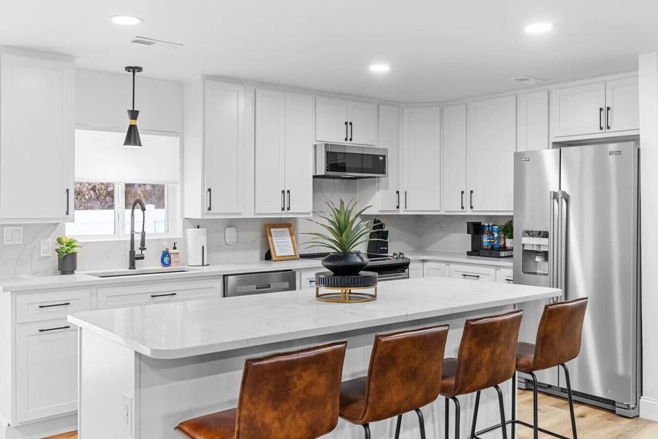 Discover a stunning, remodeled open-concept living room and kitchen with new appliances, custom quartz countertops, and backsplash. Kitchen leads to outdoor private dining patio-hot tub—perfect for cooking, entertaining, and relaxing in modern style