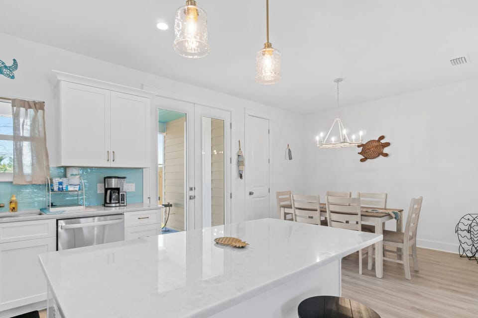 Your bright, modern kitchen flows seamlessly into the dining area, creating the perfect space for memorable meals together.