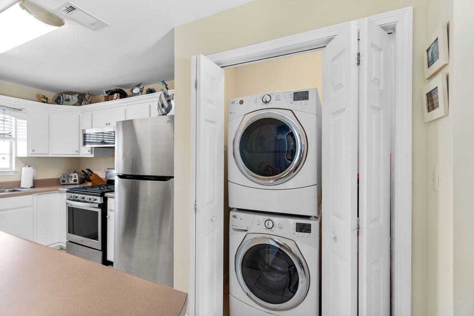 Your convenient in-unit laundry closet keeps your vacation wardrobe fresh, while the fully equipped kitchen awaits your culinary adventures.