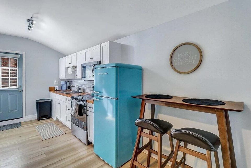Step back in time with this adorable kitchenette, featuring a retro refrigerator that adds a pop of vintage charm to your cooking space!