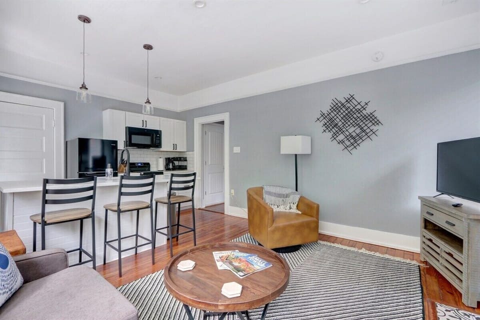 Seamlessly connected, the open living room flows into the kitchen, creating a warm and inviting space perfect for relaxing or sharing meals together.
