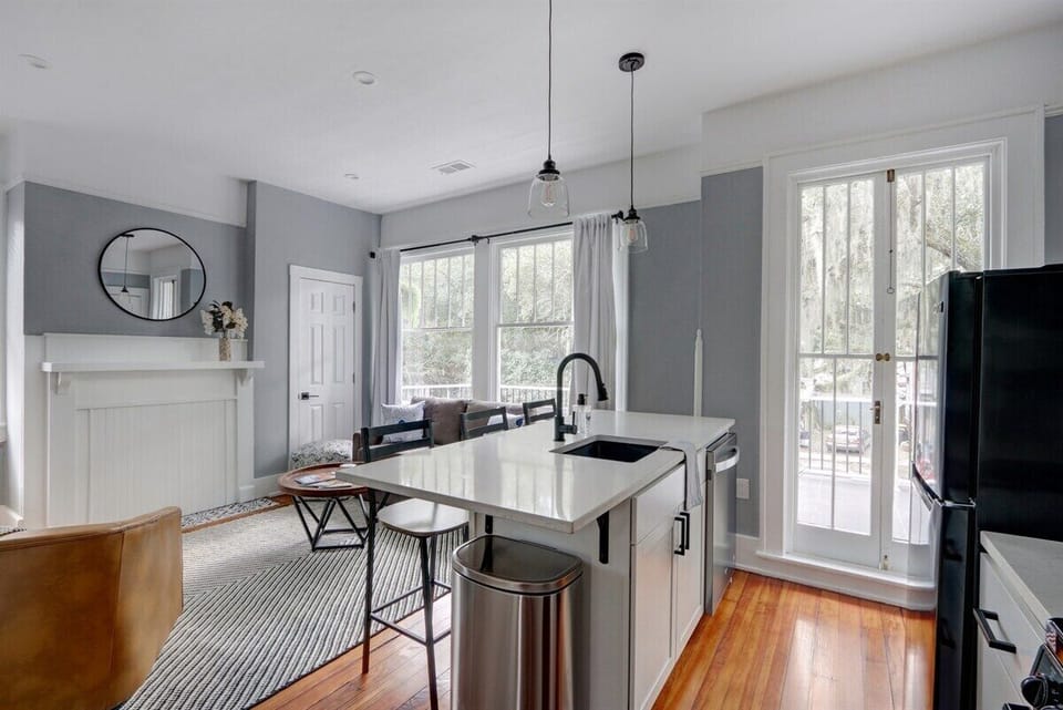 Seamlessly connected, the open living room flows into the kitchen, creating a warm and inviting space perfect for relaxing or sharing meals together.