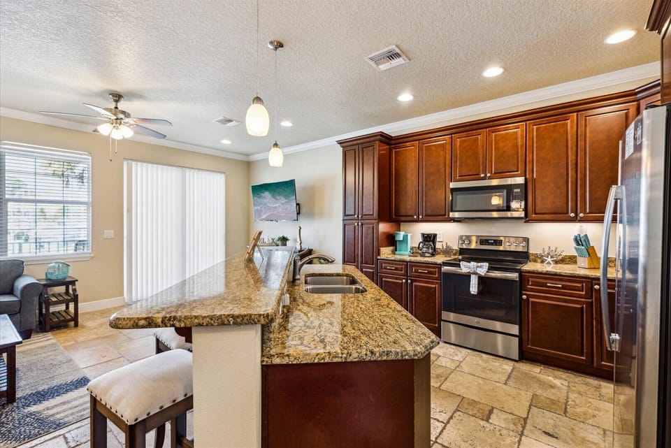 Fully stocked with stainless appliances and rich wood cabinetry—it's cooking made effortless.